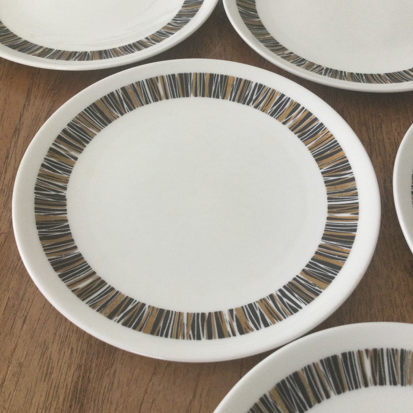 1960s Royal Tuscan Wedgwood Cascade set of 6 side plates. Black and gold retro stripes on white china.
