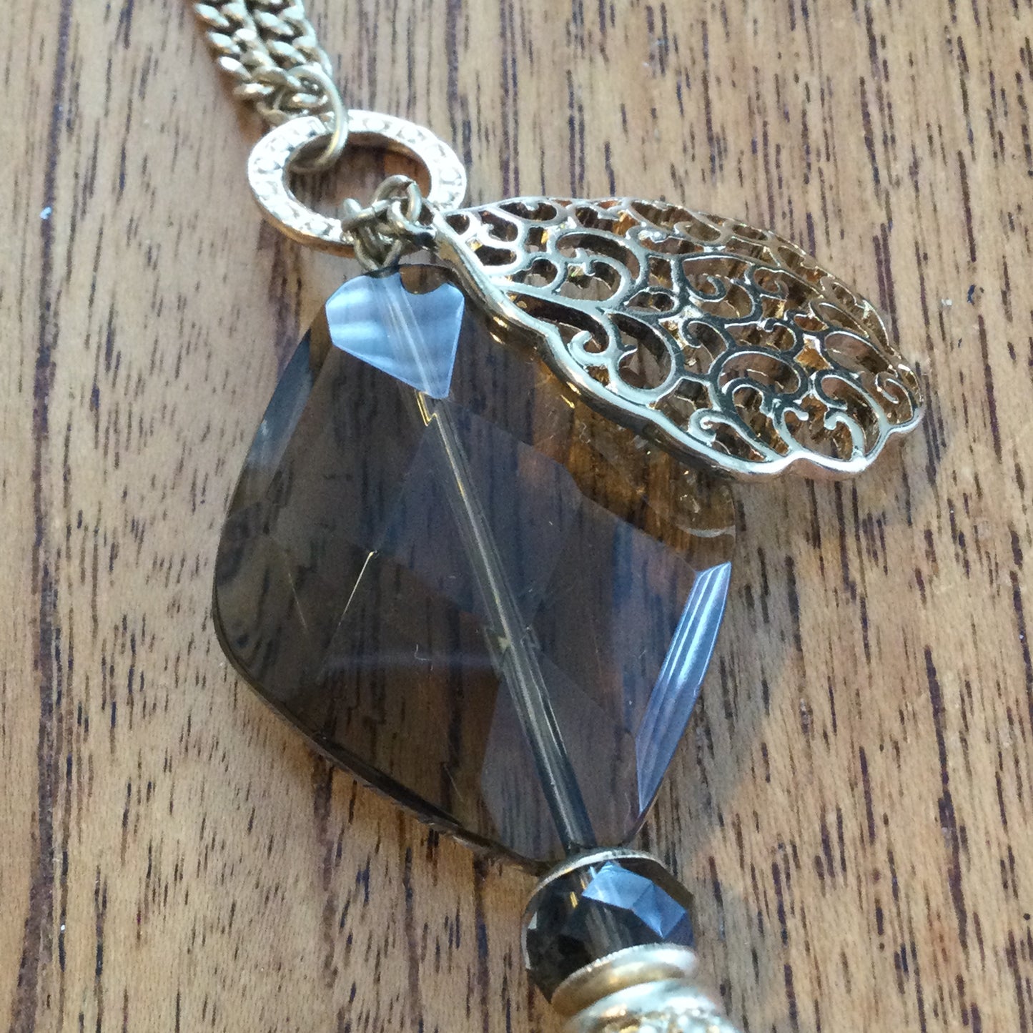 M&S Statement Necklace. Long 28". Dangling pendant gold tone with smokey quartz colour large glass bead. Boho feel