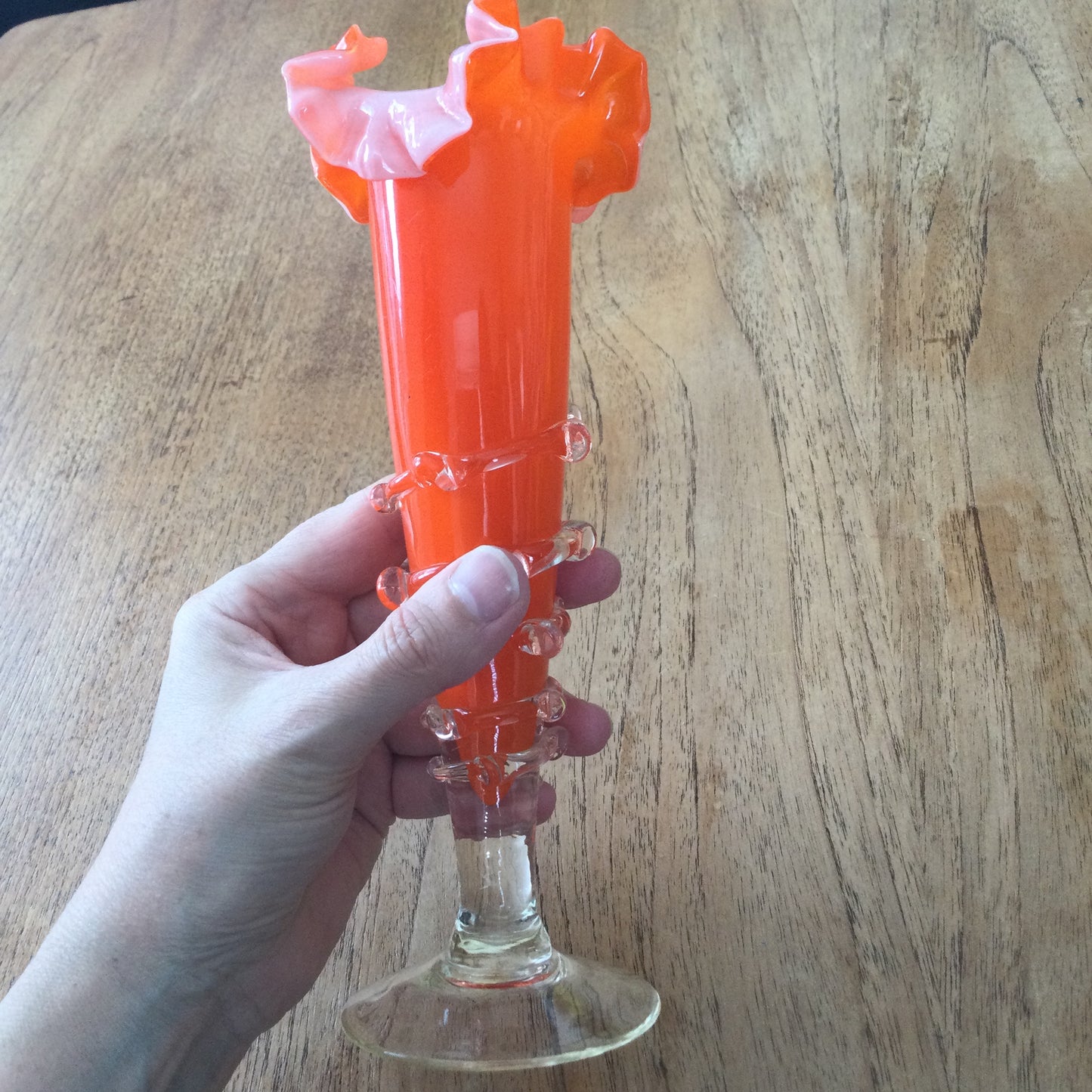 Mid century 1960s orange Murano style vase. Chinese Plum Blossom. Frilly fluted edge. Stemmed bottom.