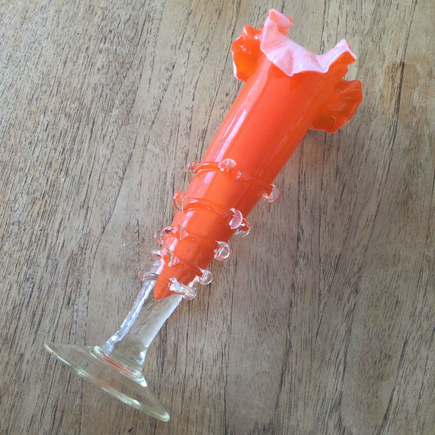 Mid century 1960s orange Murano style vase. Chinese Plum Blossom. Frilly fluted edge. Stemmed bottom.