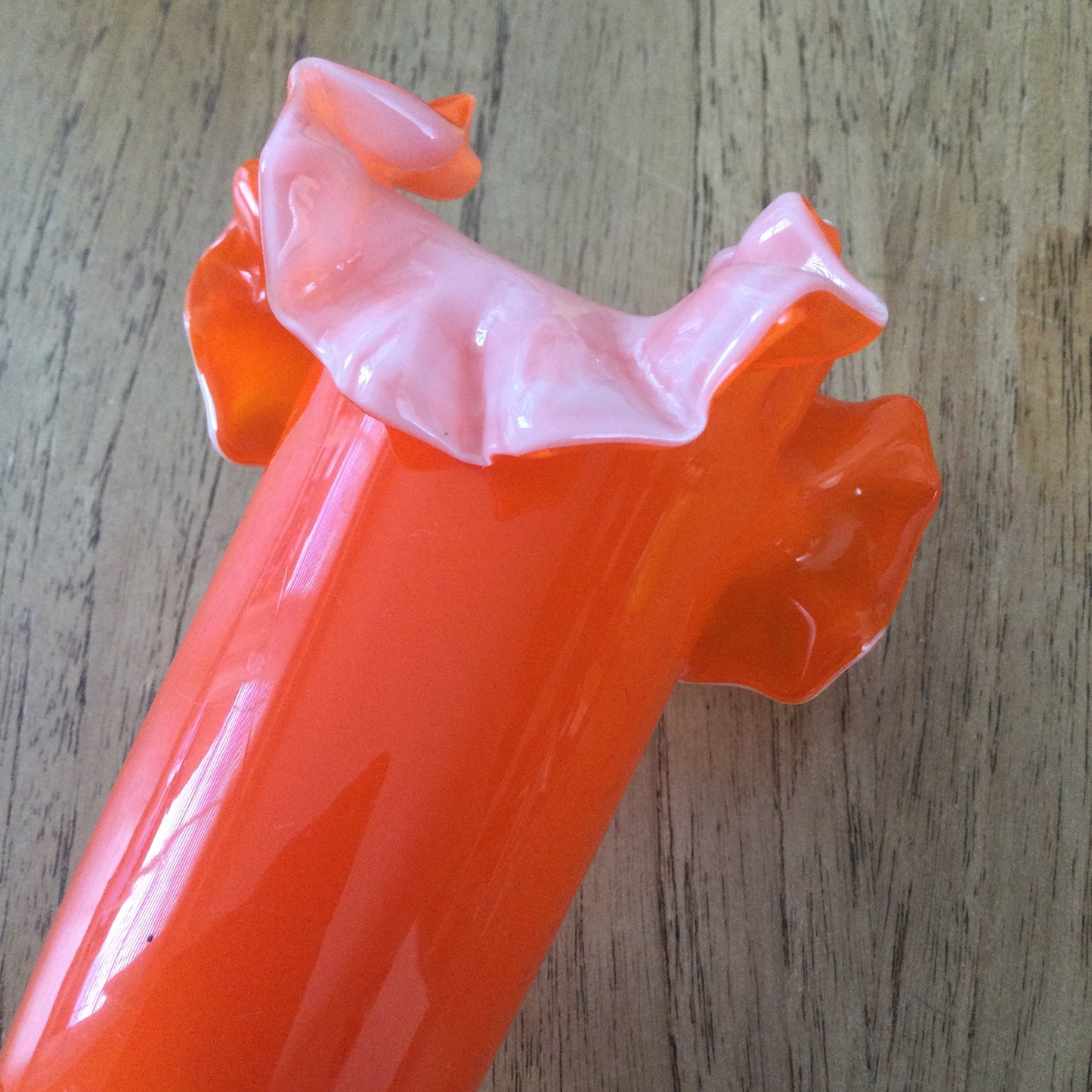 Mid century 1960s orange Murano style vase. Chinese Plum Blossom. Frilly fluted edge. Stemmed bottom.