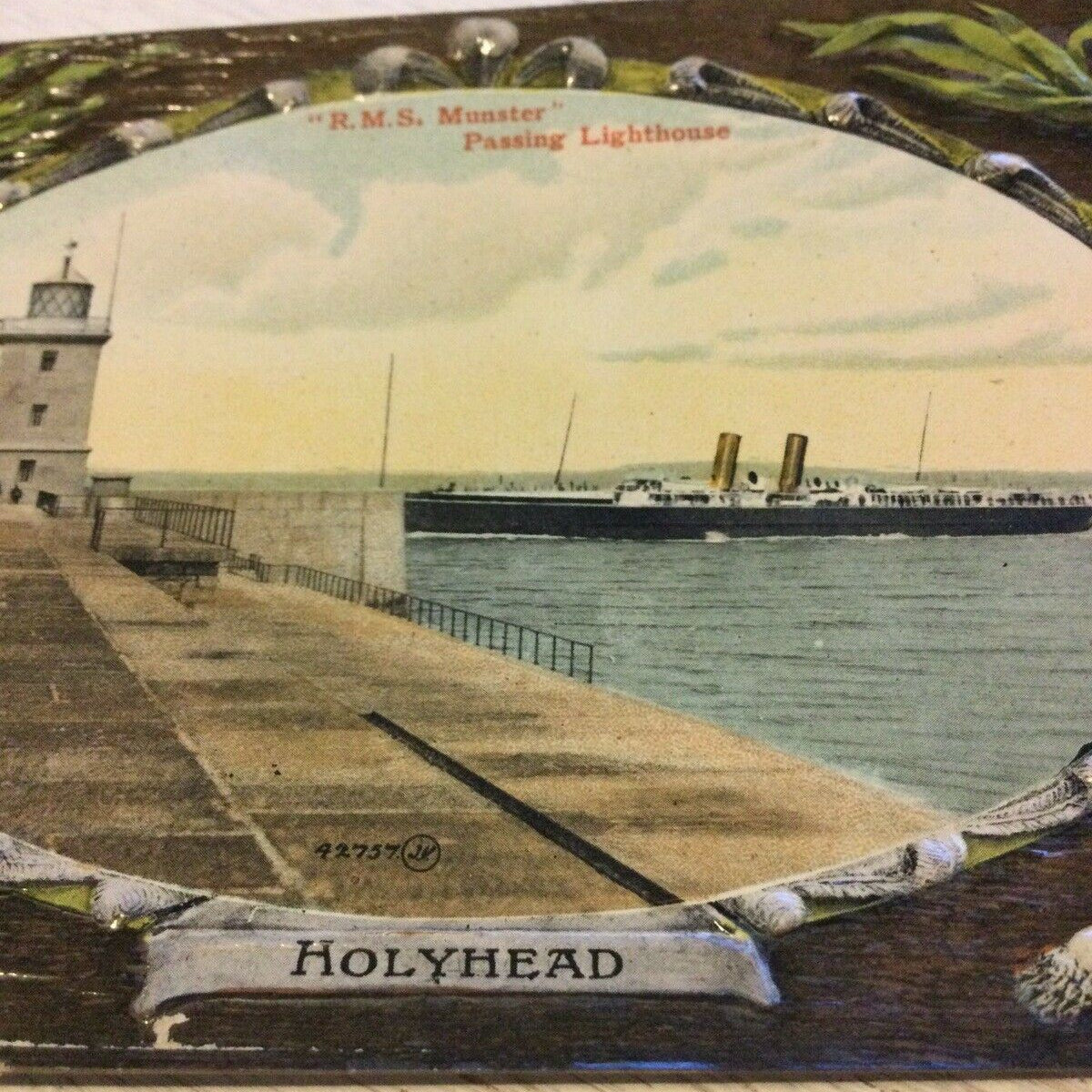 Vintage Embossed Postcard - WALES - Holyhead - RMS Munster Passing Lighthouse - Leek Border - Wales