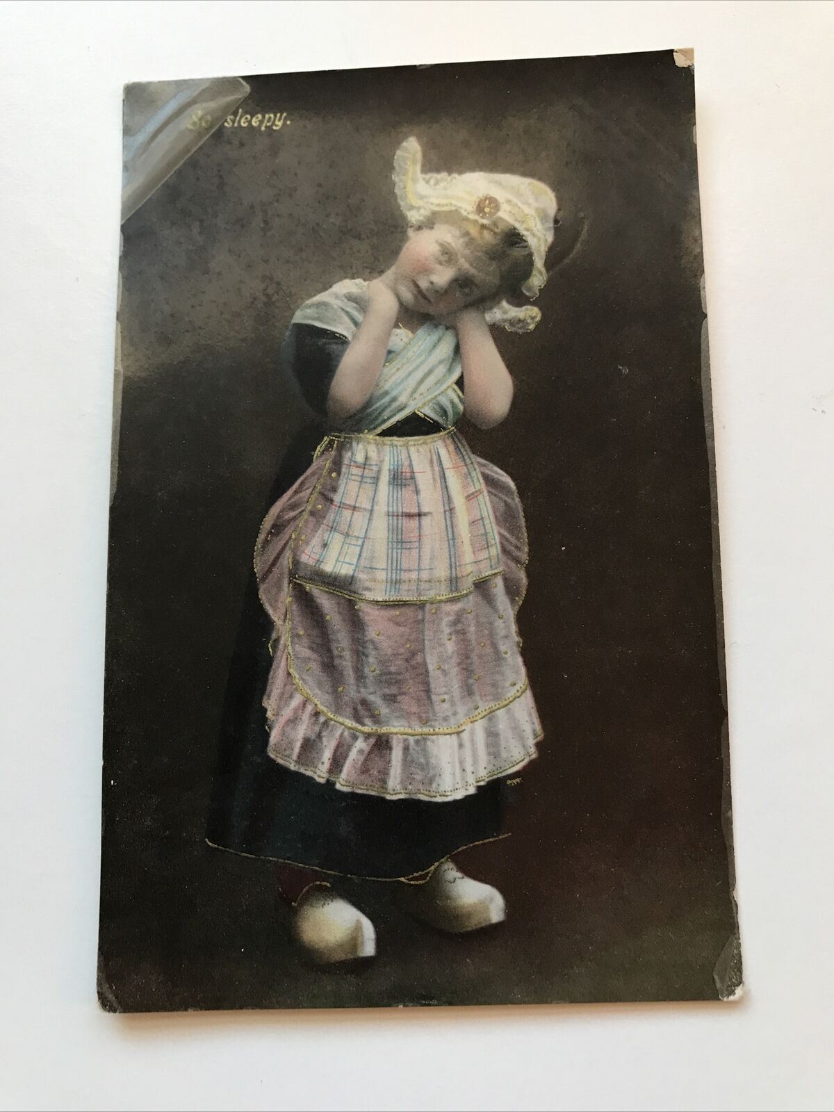 Antique C1905-1920 Philco RP Postcard Girl In Dutch Costume With Clogs. So Sleepy. Tinted.