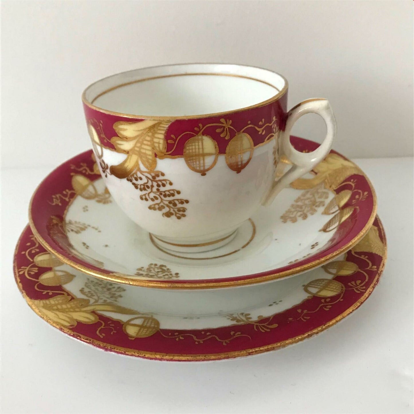 Beautiful bone china trio- cup, saucer, side plate. Deep pink & gold c.1920s Festive Christmas