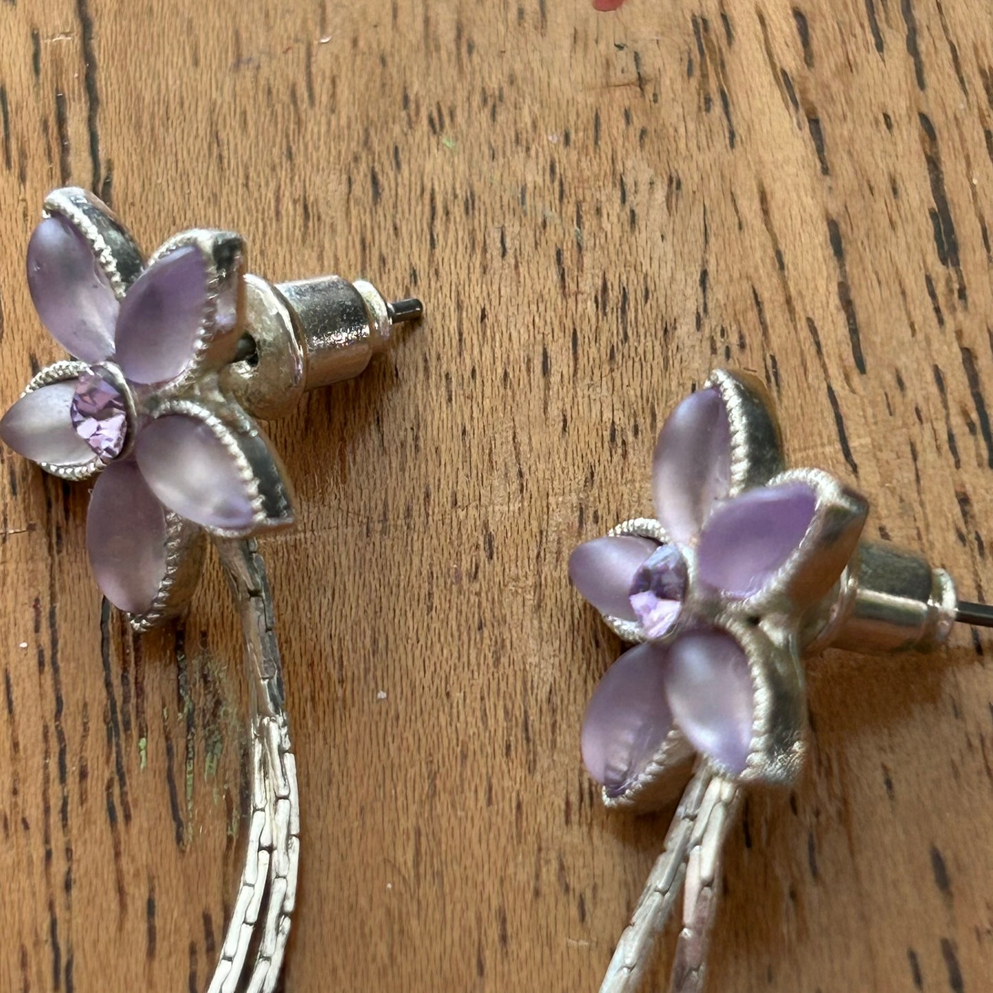 Pretty Silver Tone Drop Earrings. With Pale Pinky Purple stones. Flower shape with silver dangly pieces.