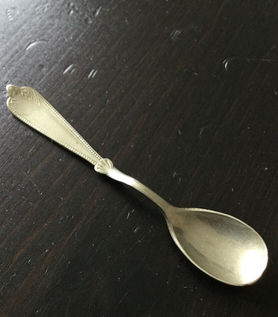 Pretty little vintage silver plated mustard spoon. Afghan F.W Silver. Approx 4" long. Fancy edge.