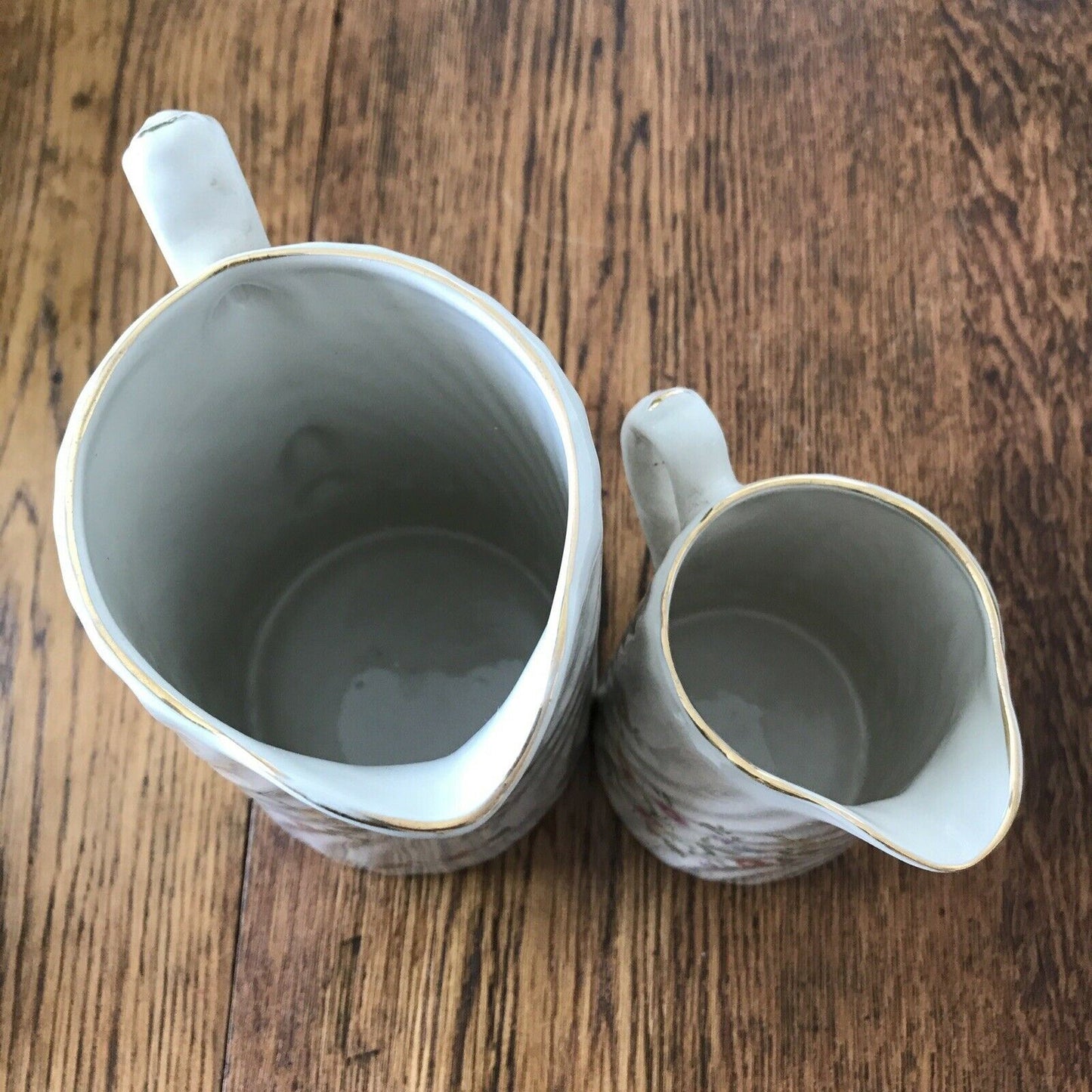 Pair Of Pretty Vintage Floral Jugs. Elegant. White With Pastel Flowers. Textured swirl design.